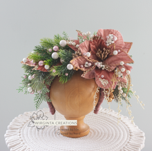 Load image into Gallery viewer, Christmas-inspired flower headband, colours: green, mauve, gold, white. Headband placed on wooden oval stand. Creator-Wirginta Creations. Photography prop.