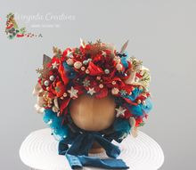 Load image into Gallery viewer, Artificial flower bonnet for 9-24 months old bonnet is placed on wooden stand. Bonnet Colours: Turquoise Gold, Red. Photography prop-Wirginta Creations the creator