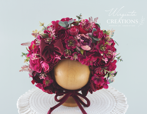 Flower bonnet on a wooden ball stand. For 12-24 month sold, photography prop for kids. Made using burgundy artificial flowers