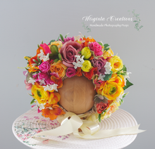 Load image into Gallery viewer, Colourful flower bonnet on wooden stand, tulle yellow tie, photography prop for 6-24 months old, created by Wirginta Creations