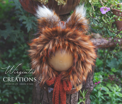 Burnt orange fox bonnet decorated with faux fur on a wooden stand. Photography prop. Creator - Wirginta Creations. 