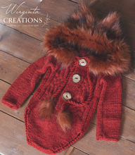 Load image into Gallery viewer, Knitted hooded fox romper for 9-18 months old. Photography prop, burnt orange colour. Hood decorated with faux fur. Romper placed on wooden background. Wirginta Creations - the creator