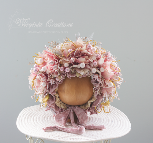 Pale Mauve artificial flower bonnet for 9-24 months old. Christmas themed photography prop. Bonnet is placed on wooden oval stand, velour ties. Creator -  Wirginta Creations