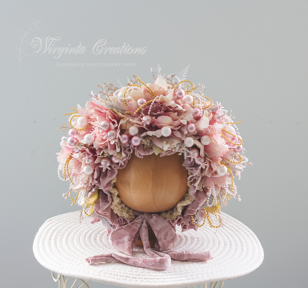 Pale Mauve artificial flower bonnet for 9-24 months old. Christmas themed photography prop. Bonnet is placed on wooden oval stand, velour ties. Creator -  Wirginta Creations
