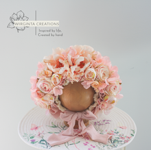 Load image into Gallery viewer, Handmade floral bonnet for babies with cream &amp; peach blooms, a charming photo prop on a wooden mannequin head.