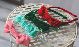 Four velour bows: mint, pink, dark green and sparkly red. plastic headbands for photography, photo prop, Bow headbands laid on metal surface. Wirginta Creations handmade photography prop, hair accessory