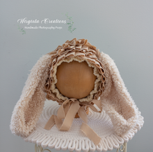 Load image into Gallery viewer, Tattered style bunny bonnet, handmade, beige colour, faux fur ears, knitted base. Bonnet placed on a wooden ball stand. Wirginta Creations the creator. Size: 6-24 months old, photography prop. Easter